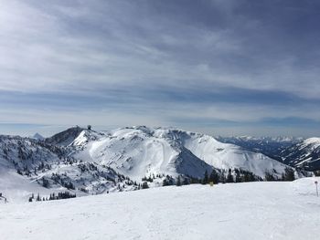 Scenic view of snow covered mountains against sky