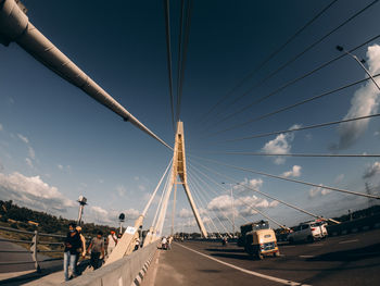 View of suspension bridge against cloudy sky