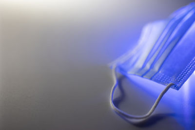 Close-up of electric light on table against wall