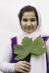 Portrait of smiling woman against white background