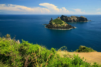 Scenic view of calm sea against cloudy sky