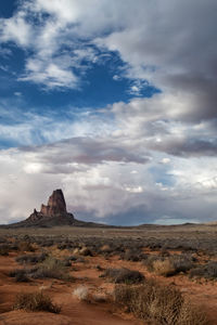 View of desert against cloudy sky