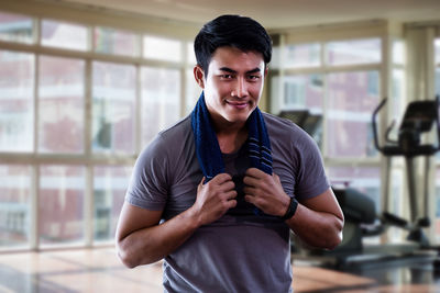 Portrait of young man standing at home