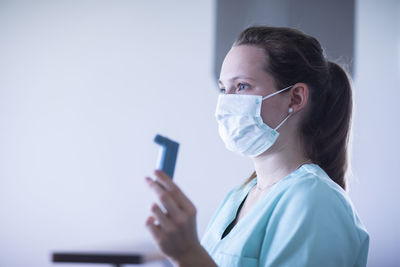 Nurse with mouthpiece and syringe