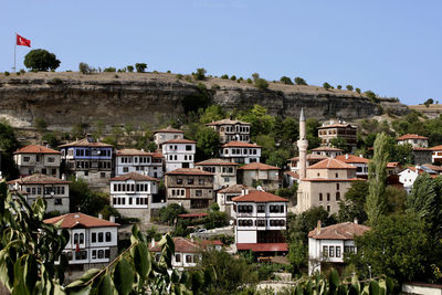 Houses in town against clear sky