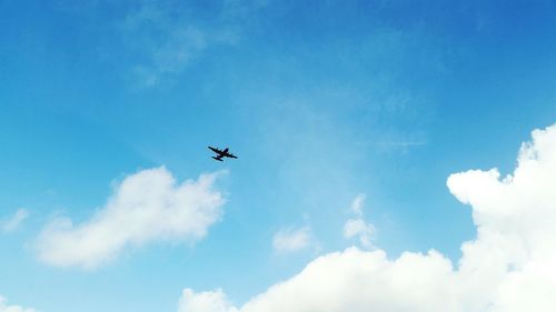 Low angle view of airplane flying in sky