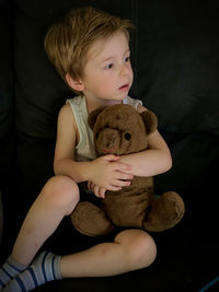 Cute boy sitting with toy