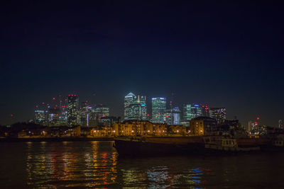 Illuminated city at waterfront