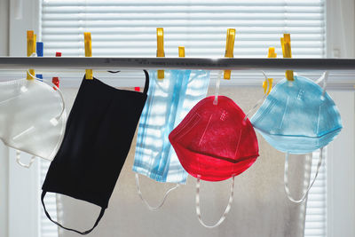 Close-up of clothes drying on clothesline against window