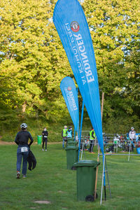 Rear view of people walking on field