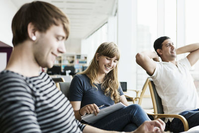 Smiling university students studying at library