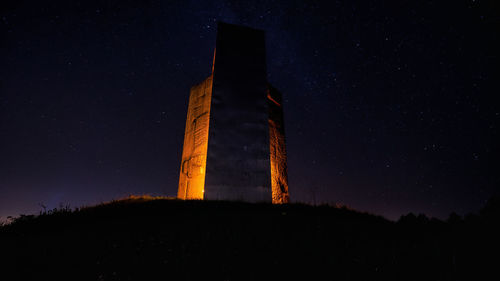 Low angle view of illuminated castle against sky at night