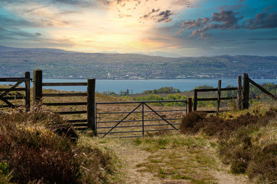 Fence on field against sky