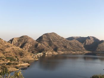 Scenic view of lake and mountains against clear sky