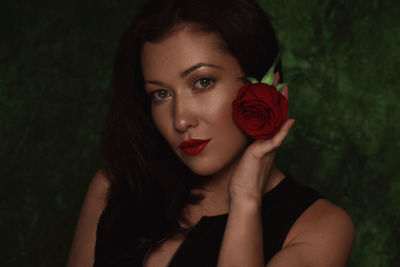 Portrait of woman with red rose