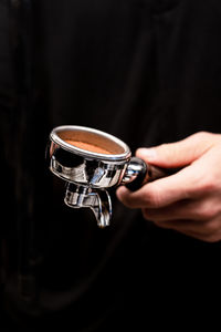 Midsection of man holding coffee