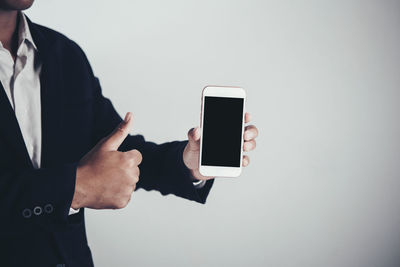 Man using smart phone against white background