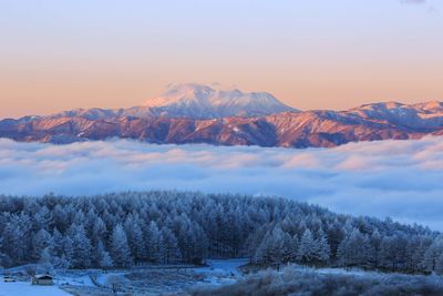 Scenic view of snowcapped mountains against sky during sunset