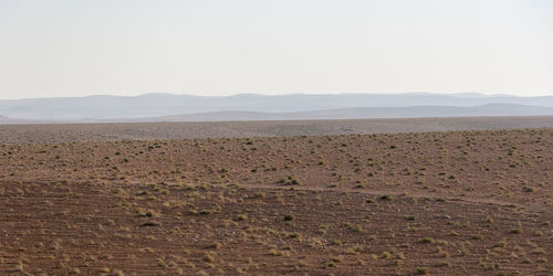 Scenic view of desert against clear sky