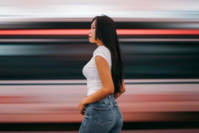 Rear view of woman standing in train kl central 