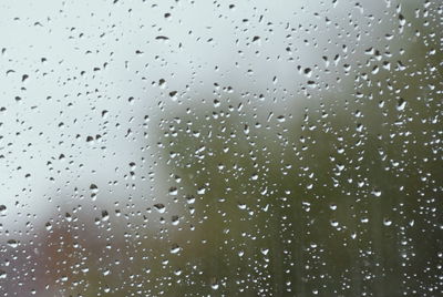 Full frame shot of wet glass window during rainy season