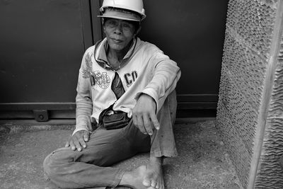 Full length of woman sitting on bench