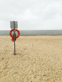 Lifeguard hut on beach against sky