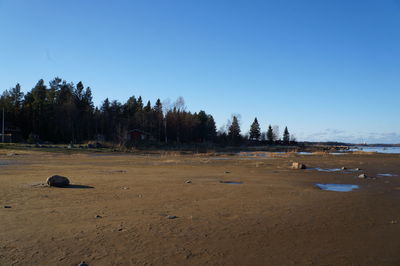 View of calm sea against clear blue sky