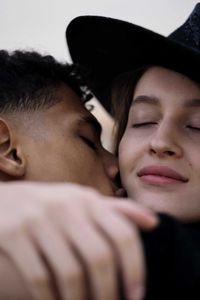 Close-up of young interracial couple hugging