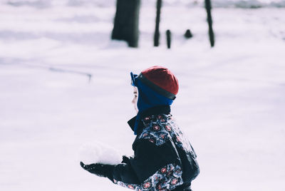 Boy on snow covered field