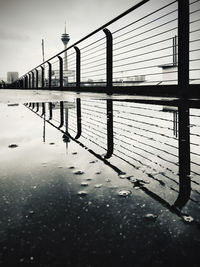 Bridge over river in city against sky