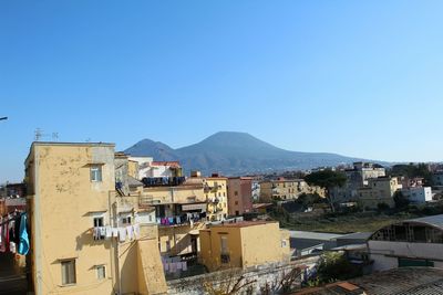 Residential buildings against clear blue sky