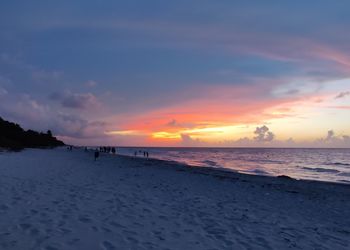 Scenic view of beach against sky during sunset