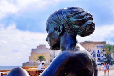 Close-up of statue against sky in city