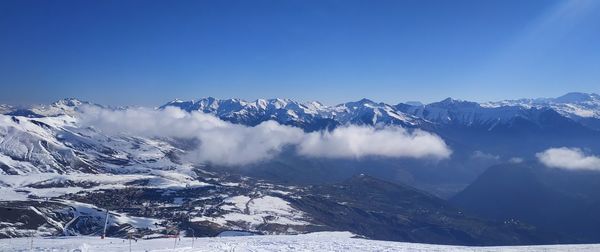 Scenic view of snowcapped mountains against clear blue sky