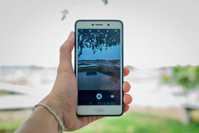 Midsection of person holding smart phone