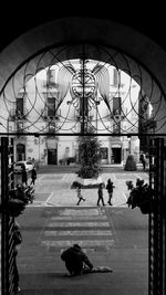 People walking on footpath in city