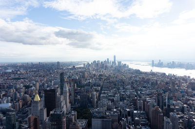 Aerial view of modern buildings in city against sky