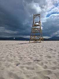 Lifeguard hut on beach against sky