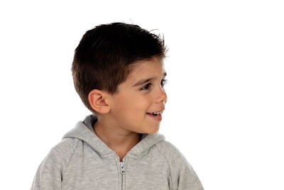 Portrait of boy looking away against white background