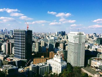 Aerial view of modern buildings in city against sky