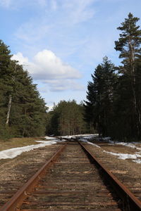 Surface level of railroad tracks against sky