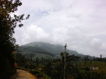 Scenic view of mountains against cloudy sky