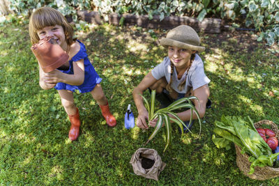 Girl and woman standing by plants