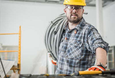 Side view of man standing in factory