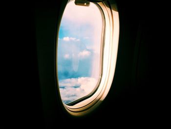 Airplane on road against cloudy sky