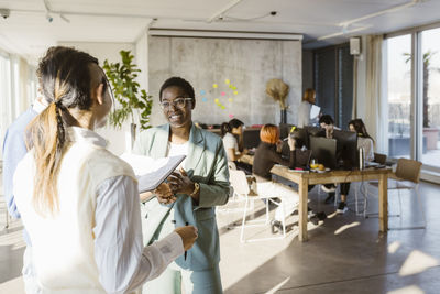 Multiracial colleagues discussing in creative office