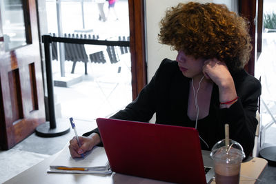 Young woman using laptop at home