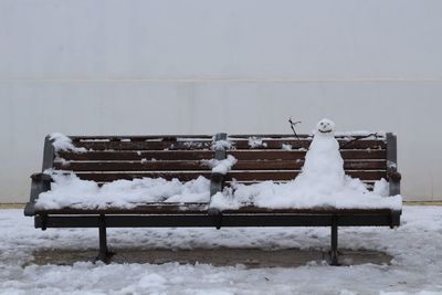 Snow covered bench in winter