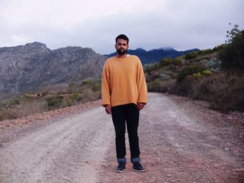 Portrait of a young man standing on mountain